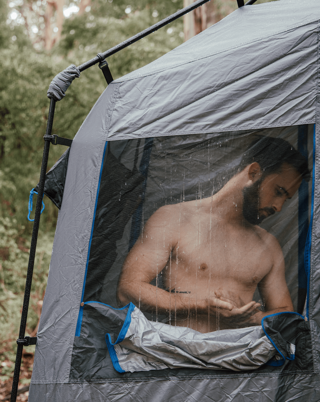 Man showering inside the ENSUITE Double, seen through the mesh window
