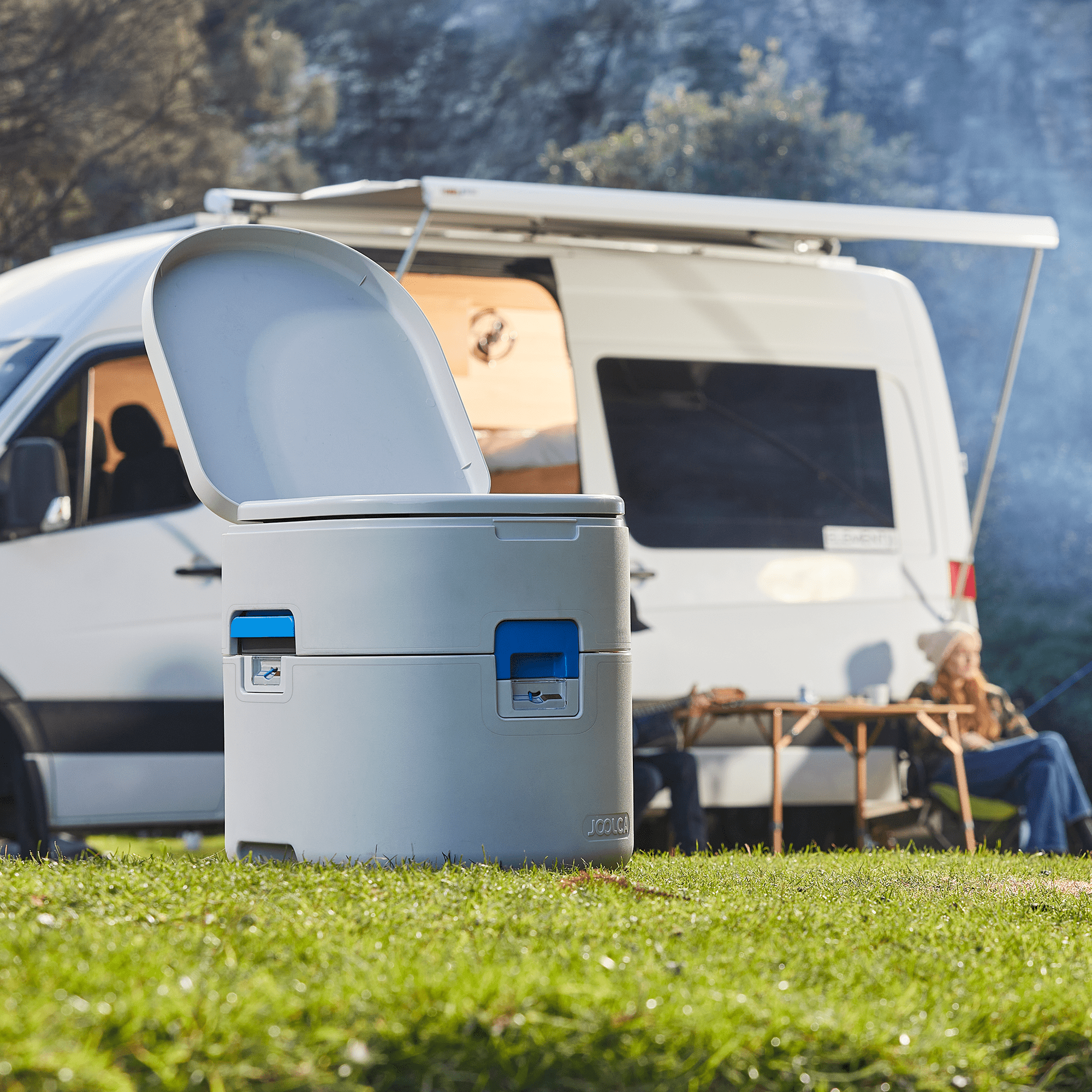 GottaGo portable toilet camping setup with campervan and mountain scenery