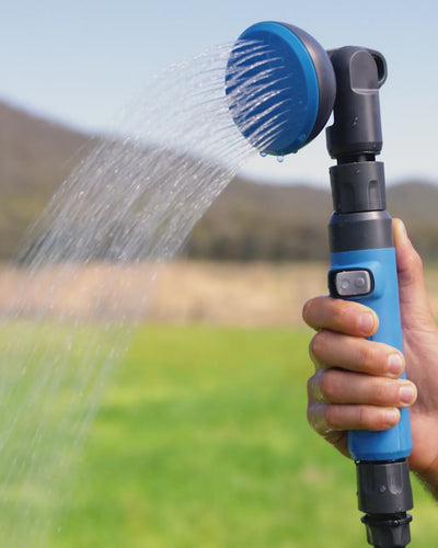 Man demonstrating proper water flow from the HOTTAP V2 outdoors.