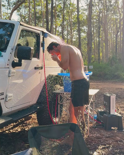 HOTTAP V2 mounted on a vehicle, running water into a camp sink at a campsite.